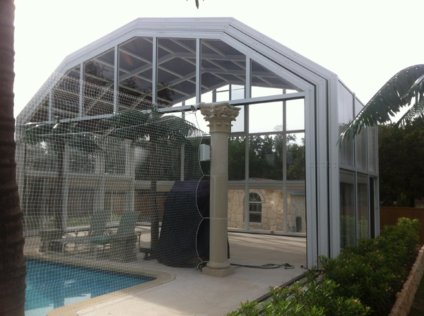 Pool and spa enclosure with screened panels